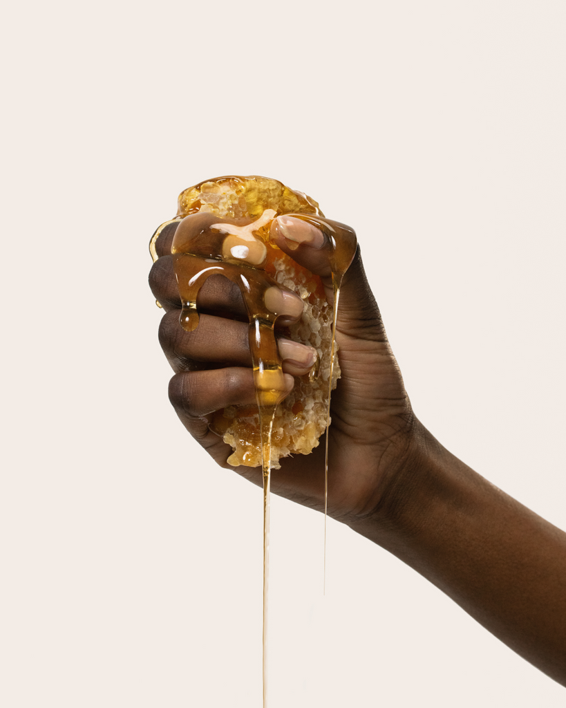 Honey dripping in hand